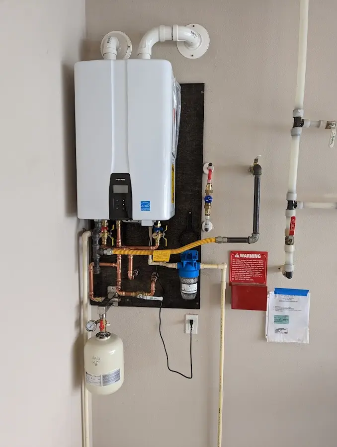 Professional plumber installing copper piping in a San Marcos home